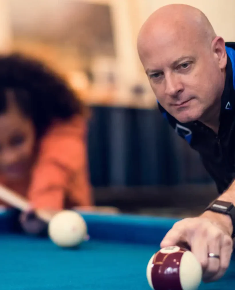 Billiards coach guiding a player through a pool lesson near Jefferson County, Alabama